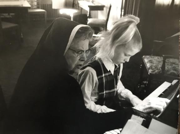 Sr. deLourdes giving a piano lesson
